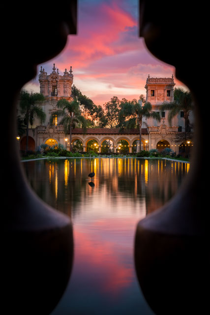 An enchanted evening at the lily pond in Balboa Park. The pond is framed through the balusters on a small bridge creating a keyhole view.