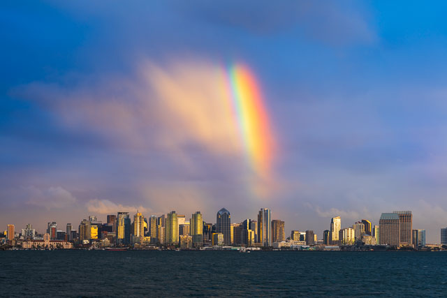 Rainbow appearing over the downtown skyline in San Diego.