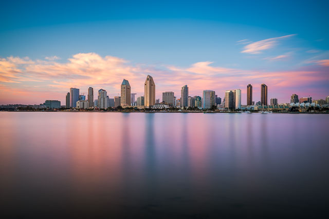 A photo of the San Diego skyline taken from Coronado. This is a long exposure giving an ethereal and airy look to the water and clouds.